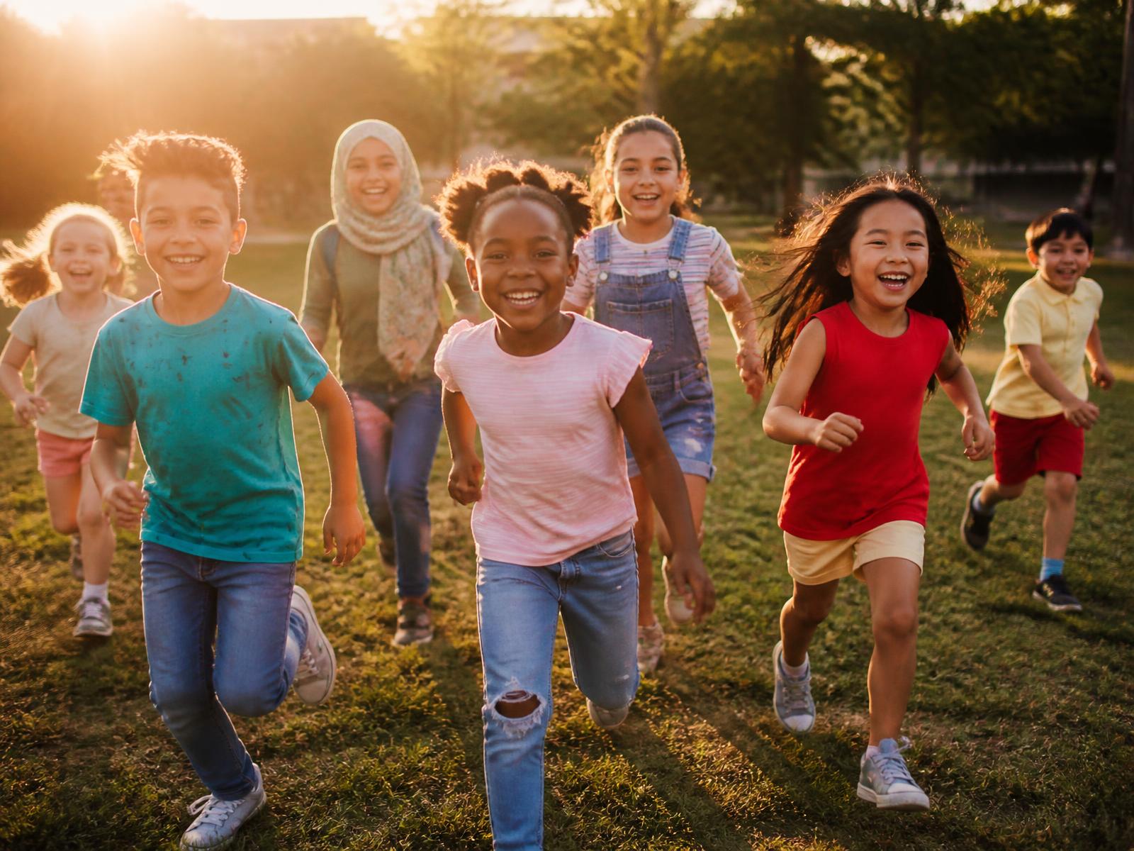 Children laughing and running together outdoors